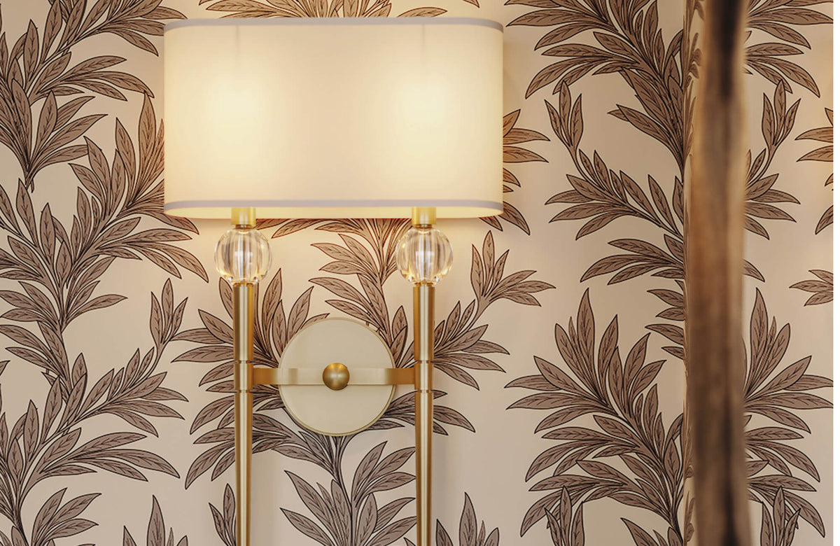 Botanical wallpaper with brass wall sconce and fabric shade, featuring warm neutral tones and leafy patterns that bring nature indoors.