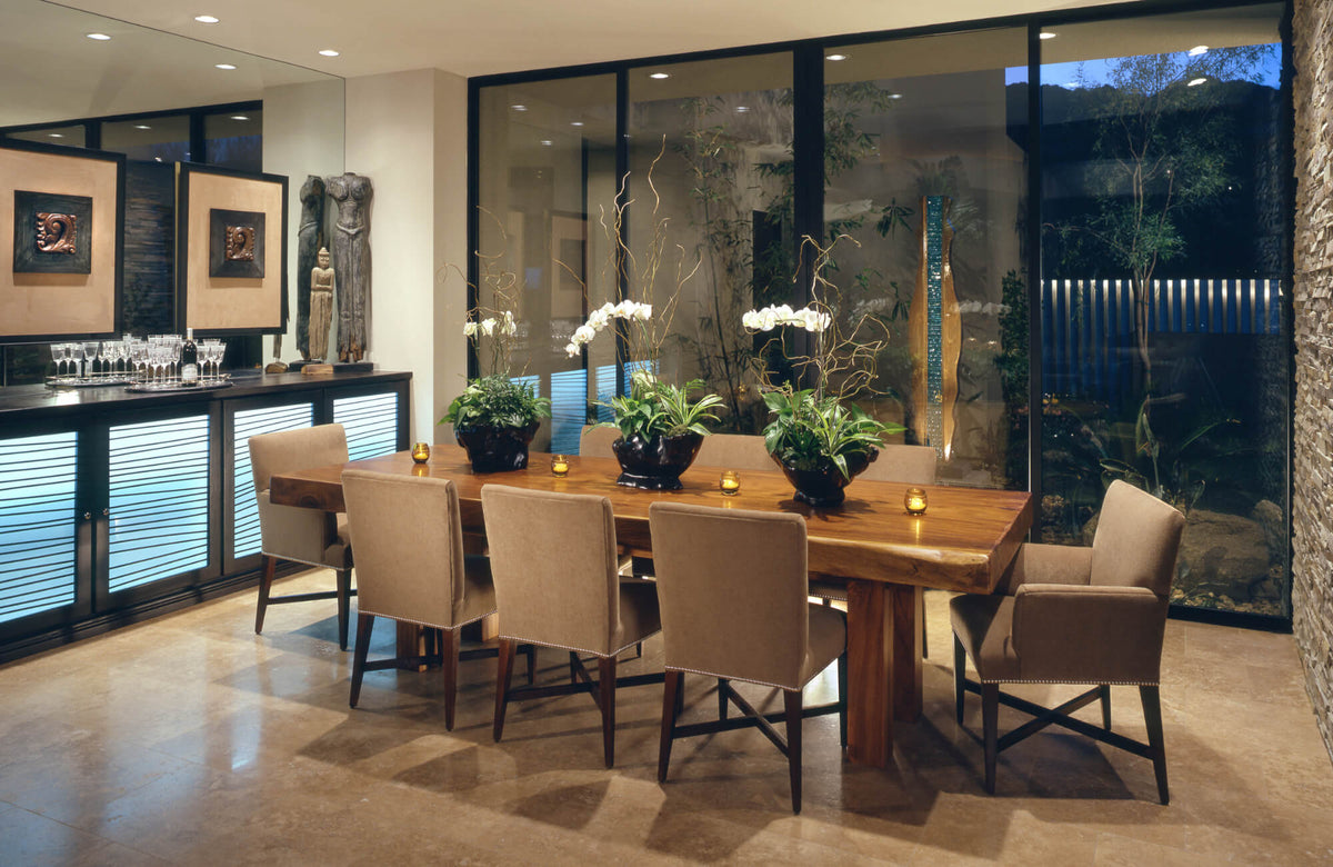 Upholstered dining chairs paired with a solid wood table create a warm, modern dining room with layered textures and refined contrast.