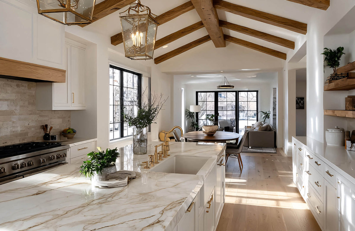 Bright modern kitchen with marble island, brass pendants, and recessed lighting designed to deliver shadow-free task illumination.