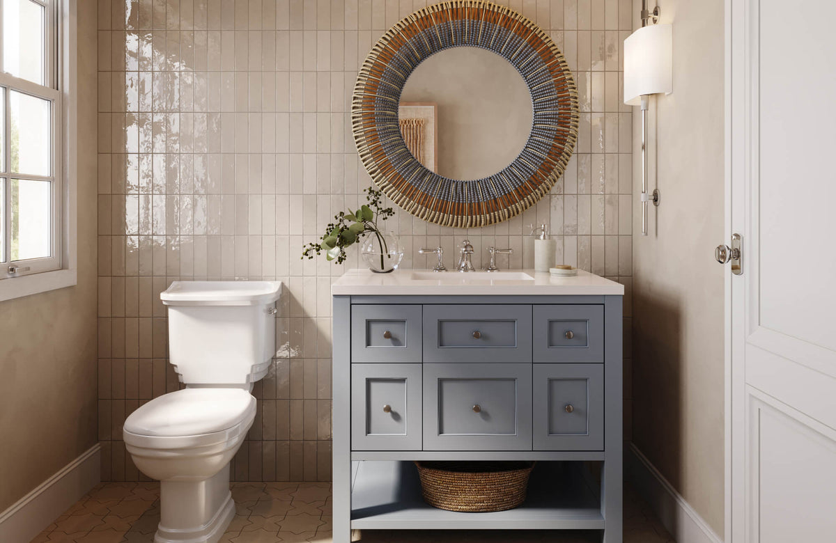 Chic bathroom with beige vertical tile, blue vanity, woven round mirror, and polished chrome fixtures.