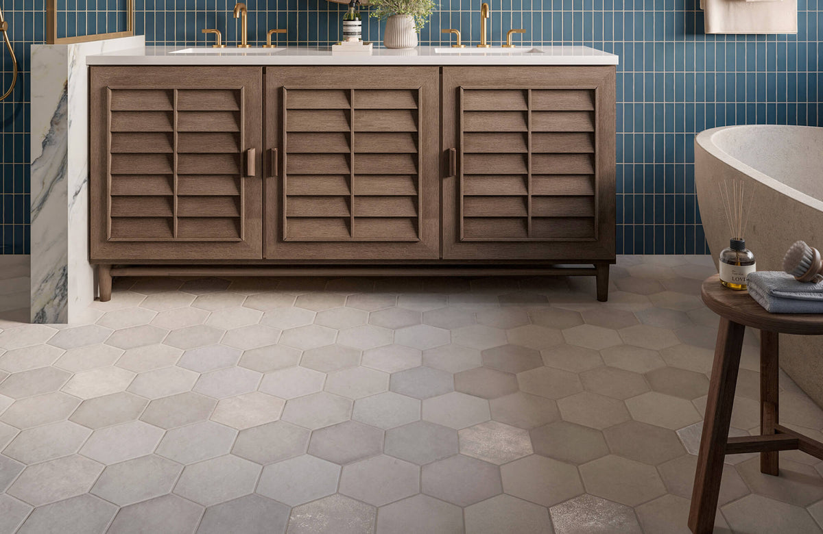 Warm-toned hexagon floor tiles in matte finish create a soft, modern base for this elegant bathroom space.