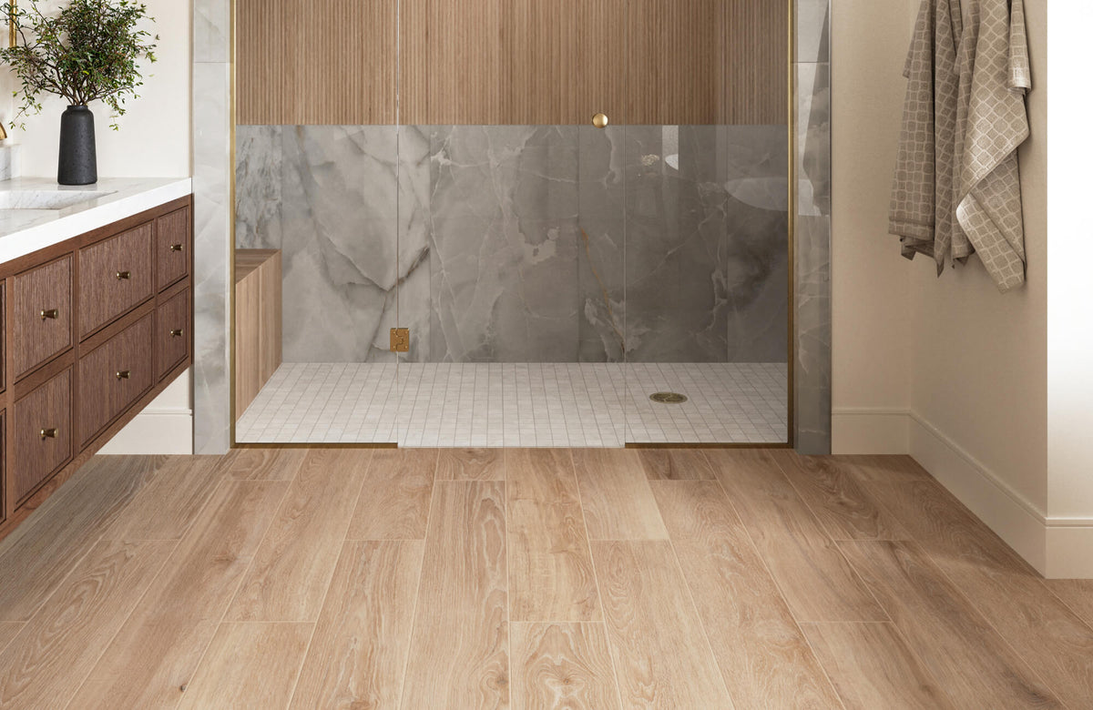 Wood look porcelain tile flooring in a modern bathroom with walk-in shower, glass enclosure, and warm wood vanity accents.