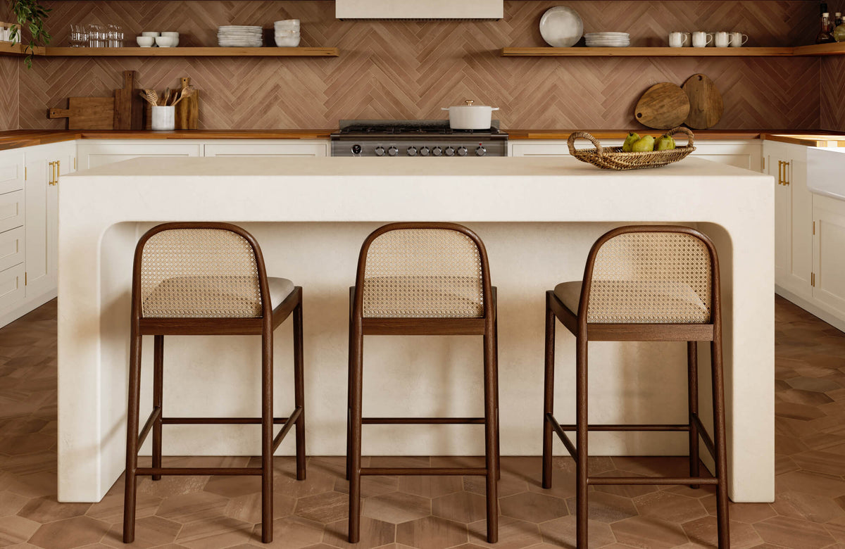 Warm terracotta kitchen tiles span the floor and herringbone backsplash, adding rich texture to this airy, modern space.