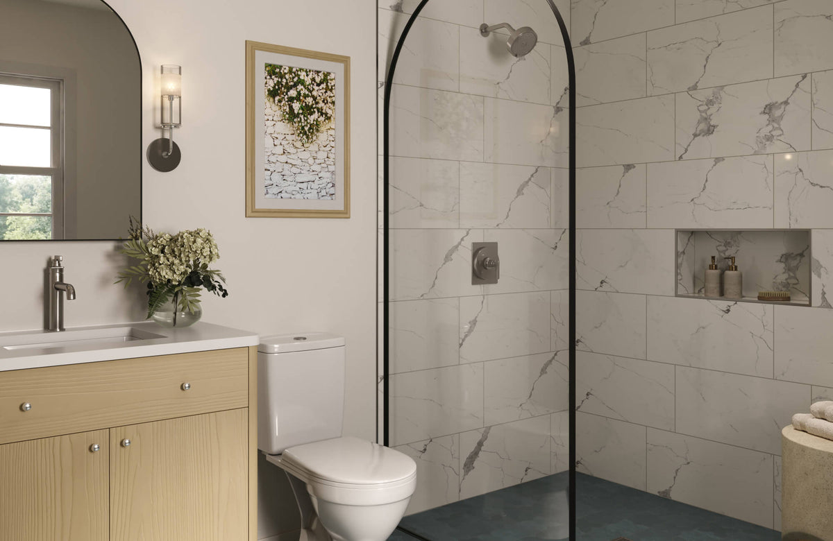 White marble-style shower tiles with subtle gray veining line a modern walk-in shower, paired with black framing to create contrast and a crisp, refreshed bathroom look.