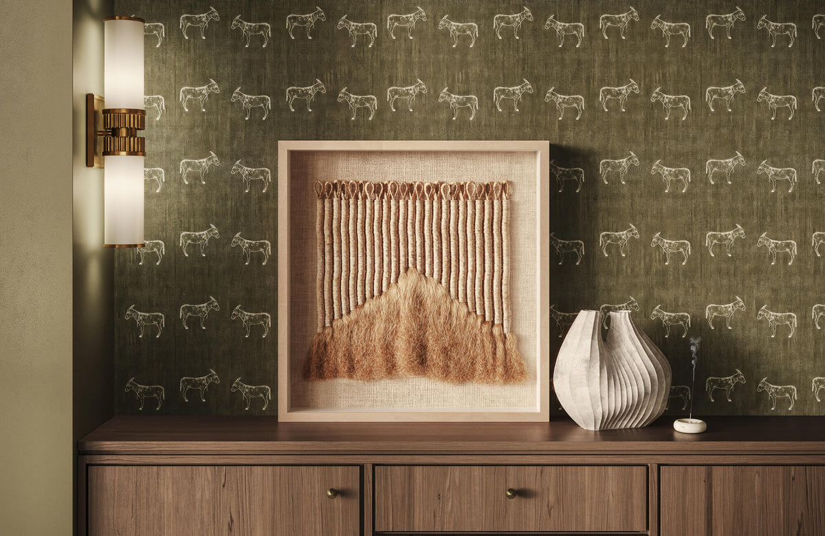 Textured wall art above a wooden console with neutral decor, soft lighting, and earthy tones creating a warm, balanced Feng Shui interior.