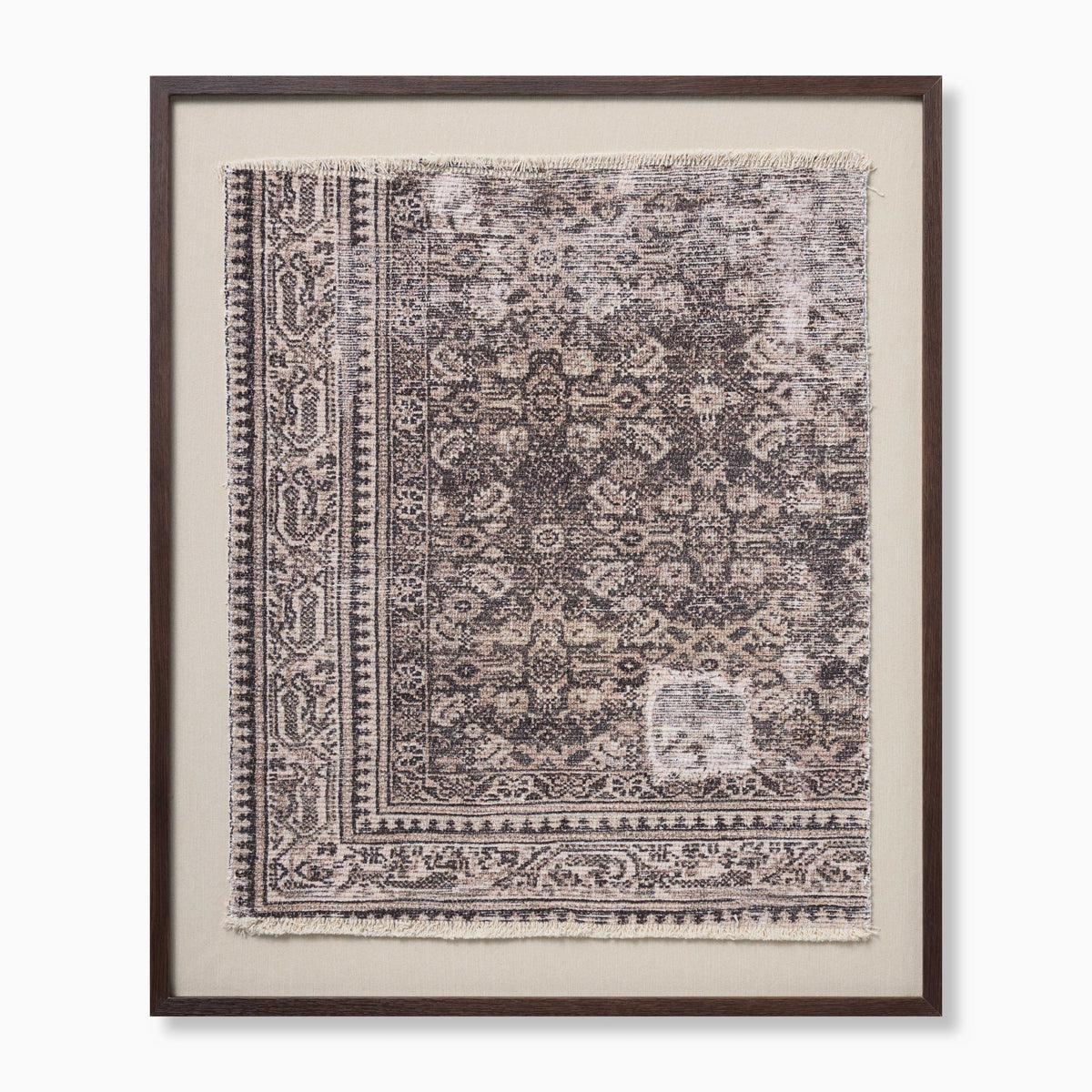 Framed textile wall art with faded geometric motifs, ornate borders, and softly frayed edges in muted beige and dark gray tones.