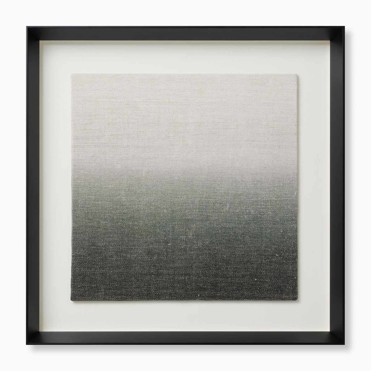 Framed textile art with a soft gradient from pale neutral tones into deeper, earthier shades, adding depth and texture in a sleek black shadowbox frame.