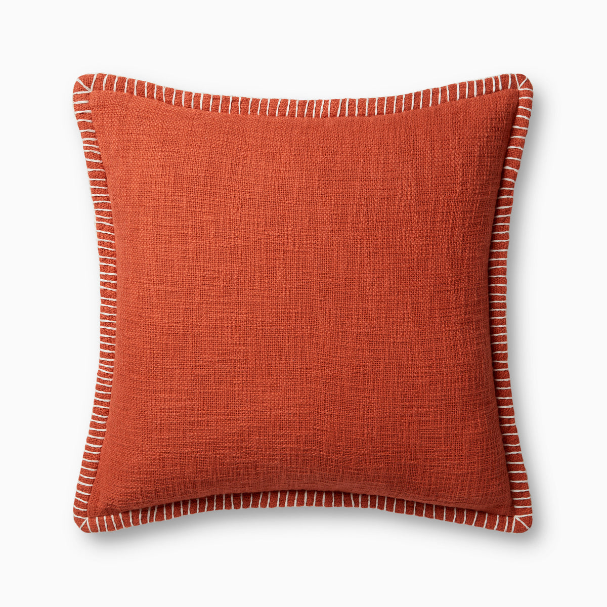 A warm dark orange pillow with woven texture, white whipstitched flange edges, and an antique bronze zipper concealed by a tailored flap, finished with a light, breathable cotton feel.