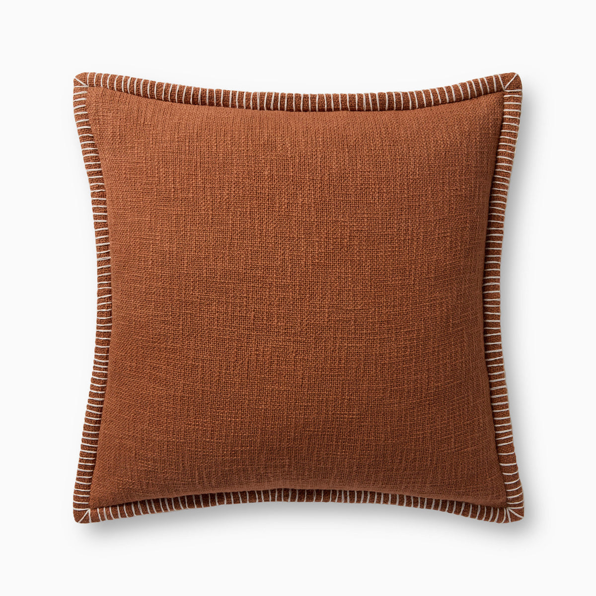 A warm reddish brown pillow with woven texture, white whipstitched flange edges, and an antique bronze zipper concealed by a tailored flap, finished with a light, breathable cotton feel.