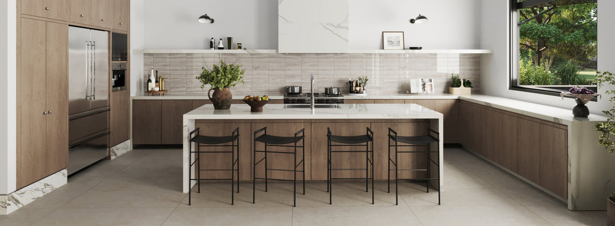 Modern kitchen featuring a sleek white island, wooden cabinetry, and a large window bringing in natural light, creating a bright and airy space