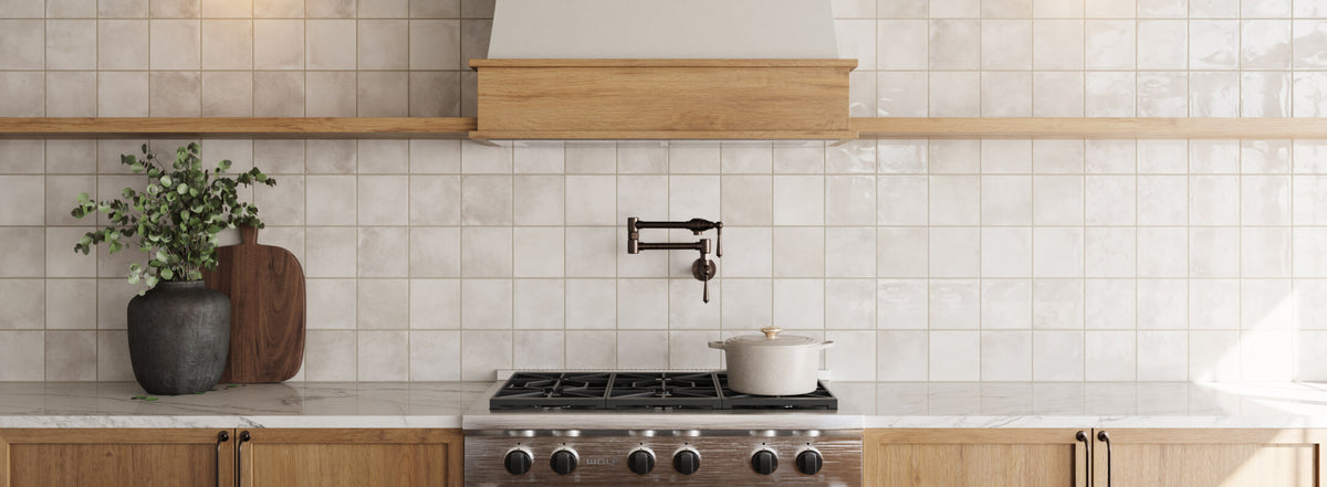 Modern kitchen backsplash featuring glossy multicolor tiles, wooden shelves, and a sleek stovetop, creating a stylish and functional space
