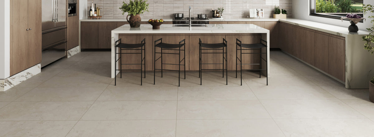 Spacious kitchen featuring a multicolor backsplash, a large marble island, and wide tiles on the floor for a clean, modern look