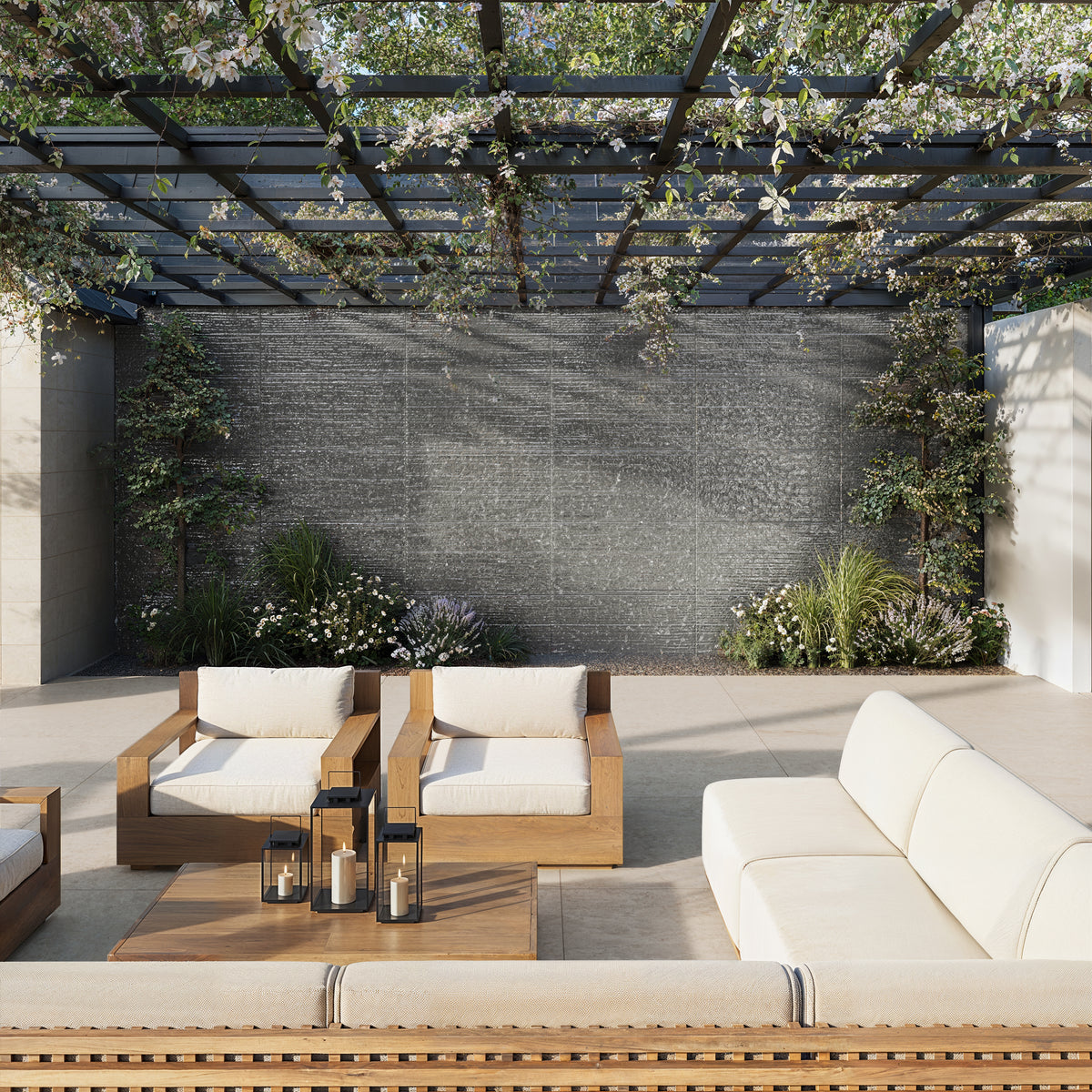 A serene outdoor lounge featuring comfortable wooden seating and a sleek porcelain-tiled wall complemented by lush greenery.