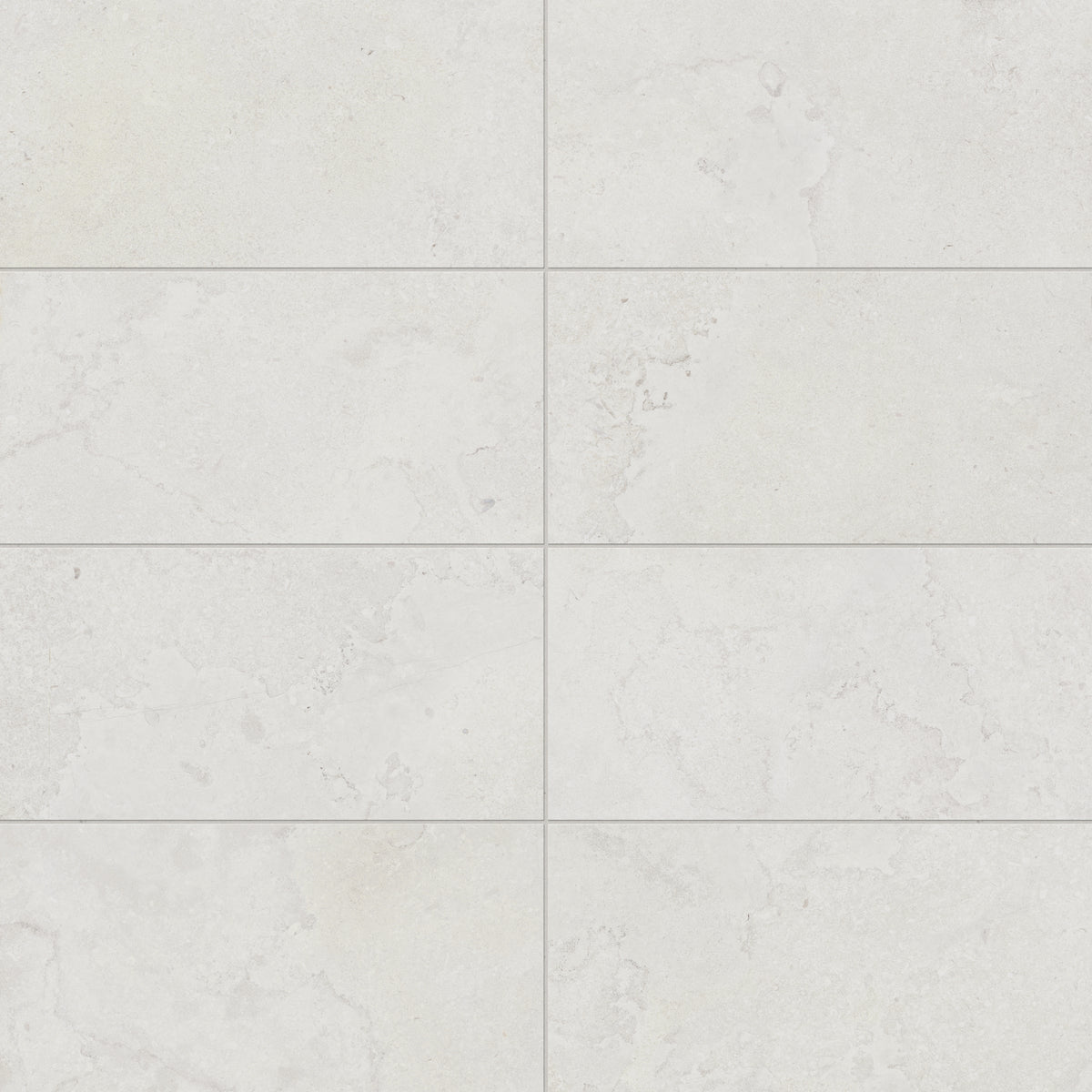 Refined 12x24 matte porcelain tile in a soft white hue with cross-cut details, offering a natural stone look perfect for contemporary interiors.