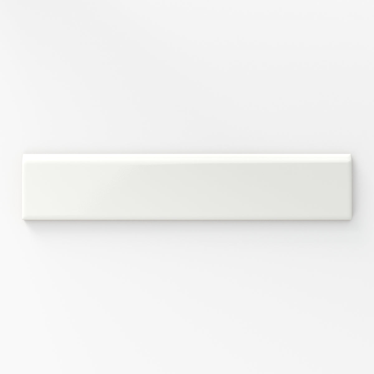 Glossy white bullnose tile with a smooth, reflective finish, perfect for creating clean, seamless edges in any design.