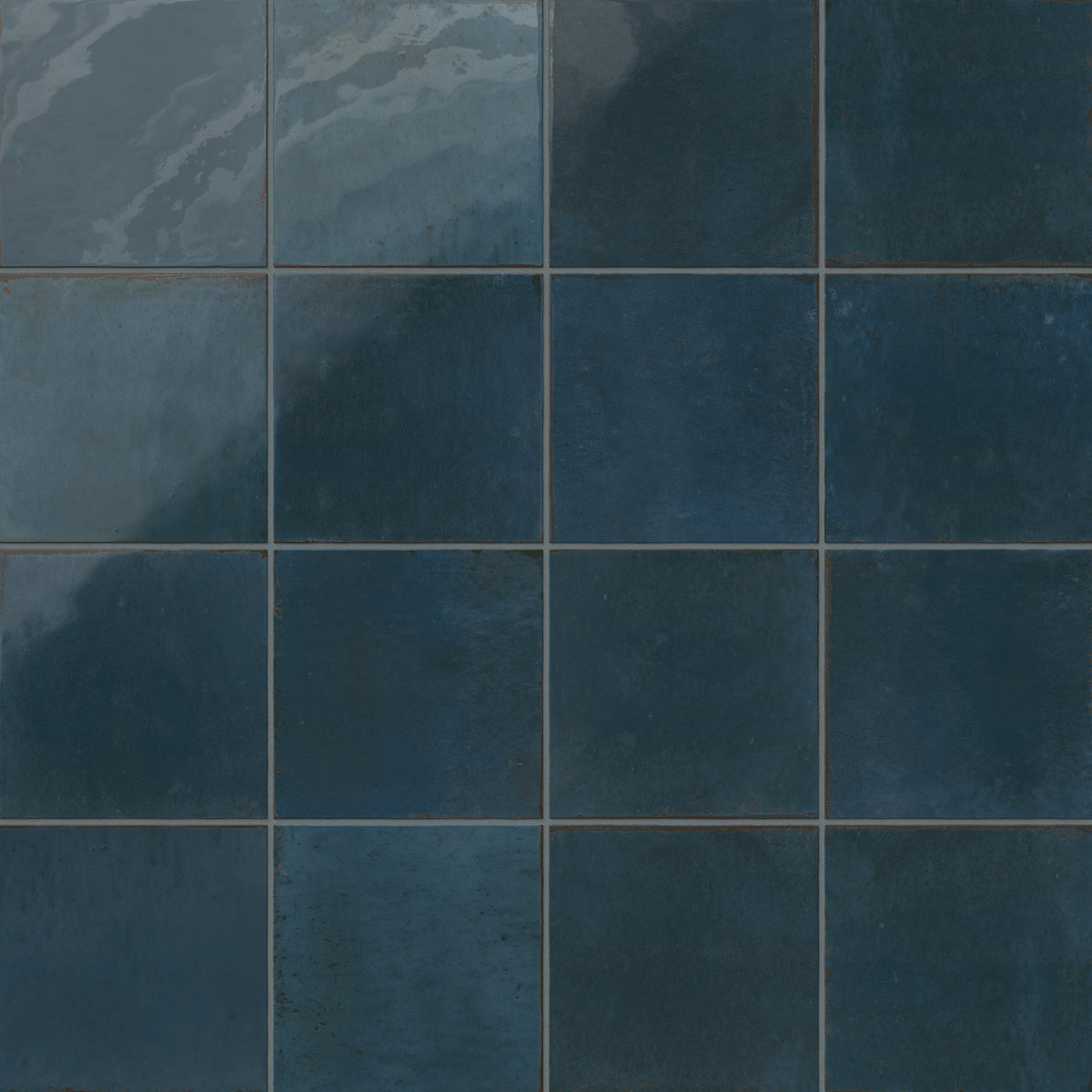 Deep blue porcelain tiles with handcrafted texture and tonal shifts for a weathered look.
