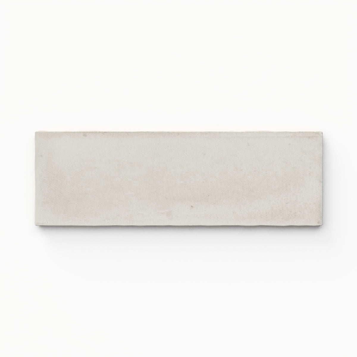 A 2x6 porcelain tile in cool off white, featuring a matte finish, soft tonal variation, and a clean, flat-edge profile.