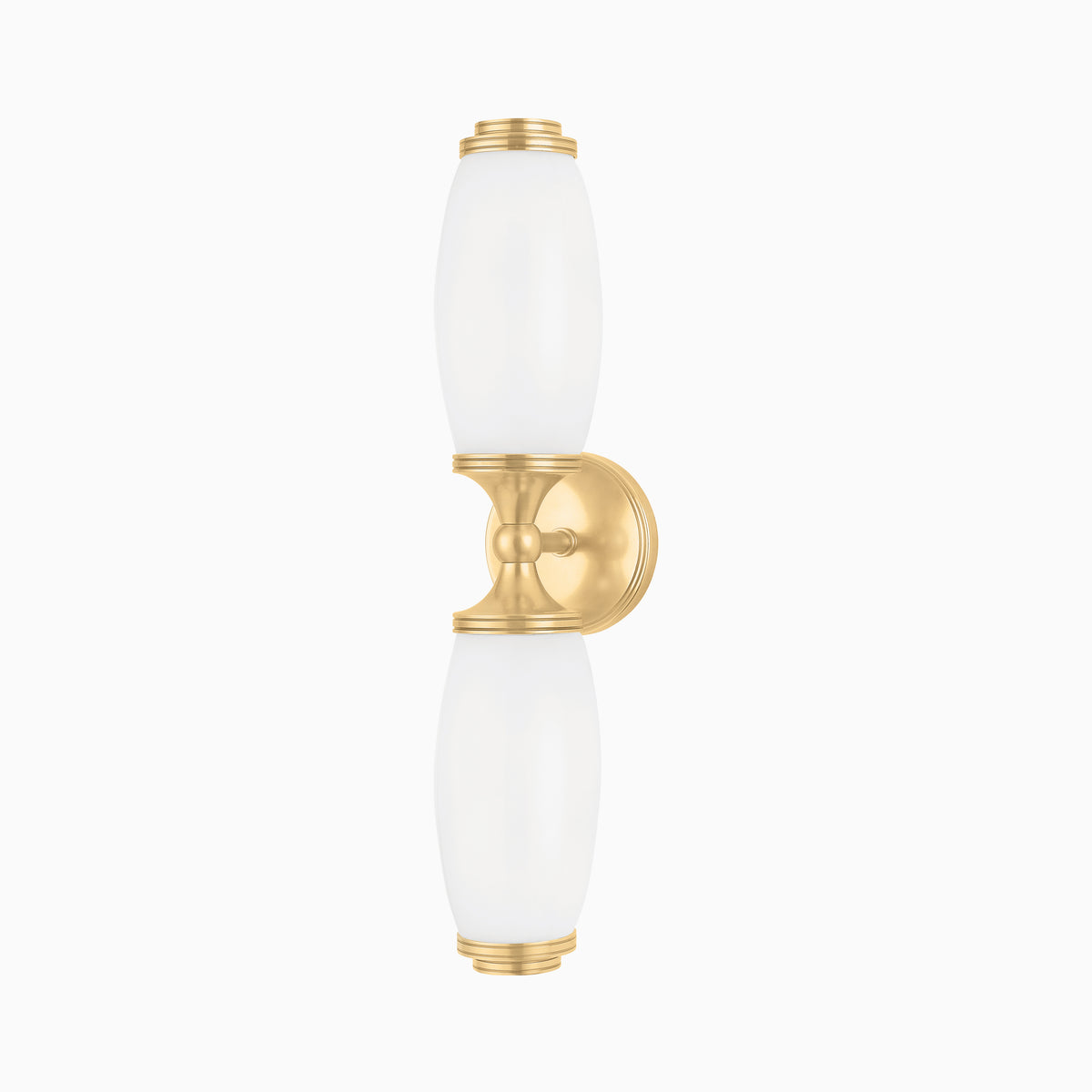 Our Cynthia Wall Sconce in Aged Brass blends smooth opal glass with curved symmetry, casting soft light through a rich, polished finish.