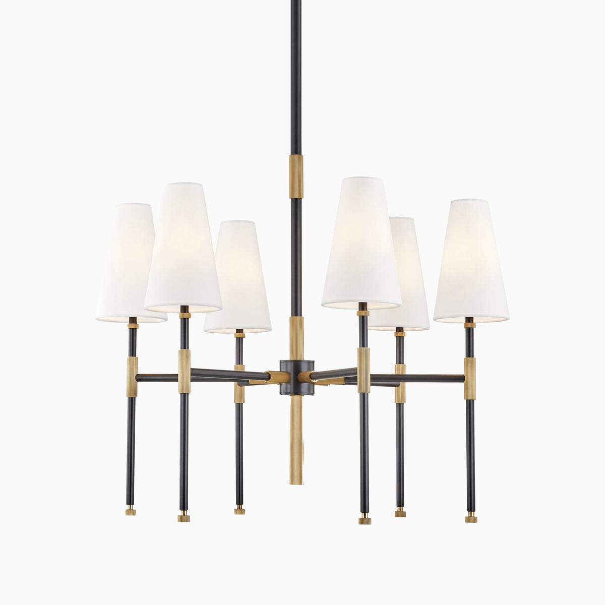 Chandelier with six white linen cone shades, aged bronze and black metal frame, radial silhouette, and central suspension stem.