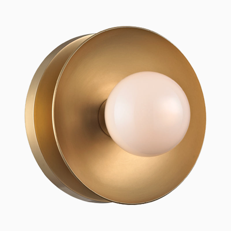 Aged brass bath and vanity light with a slim horizontal bar and round white glass shades for a clean modern look.