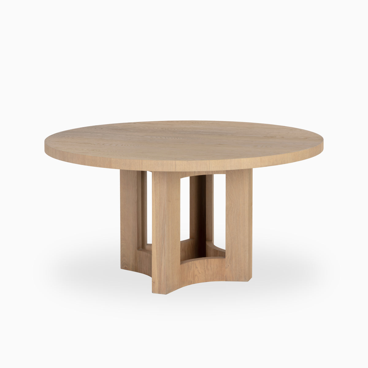 Round 60-inch dining table in natural wood with a smooth top and open geometric base, combining organic warmth with modern structure.