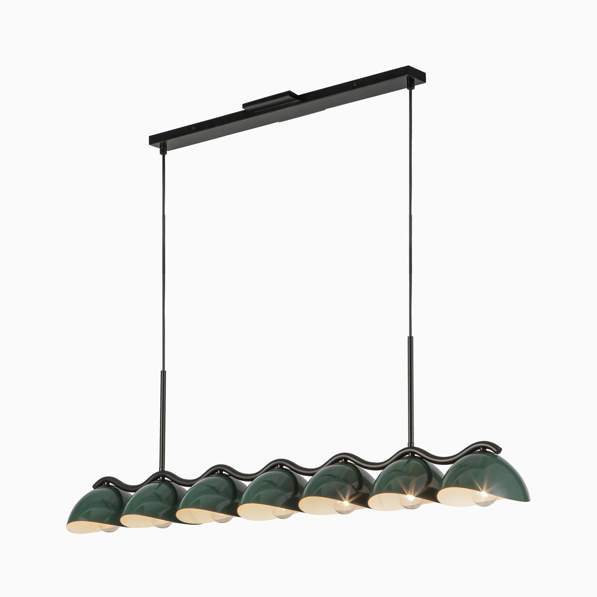 Linear pendant light with seven dark green dome shades on black bar, warm bulbs glowing beneath.