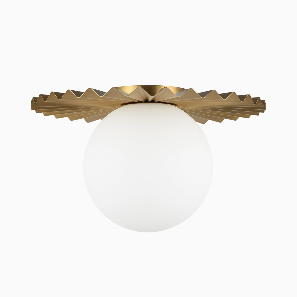 Modern flush mount light with a folded brushed gold metal shade and white globe diffuser, offering soft diffused lighting with a bold geometric form.