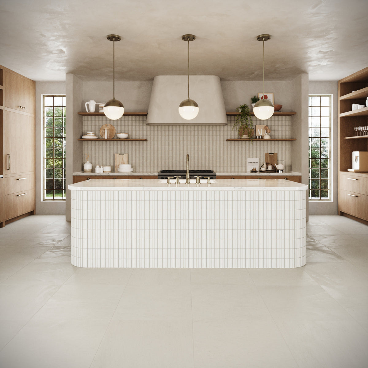 Spacious kitchen featuring warm wooden cabinetry, large windows for natural light, and a minimalist island accented with textured white tiles.