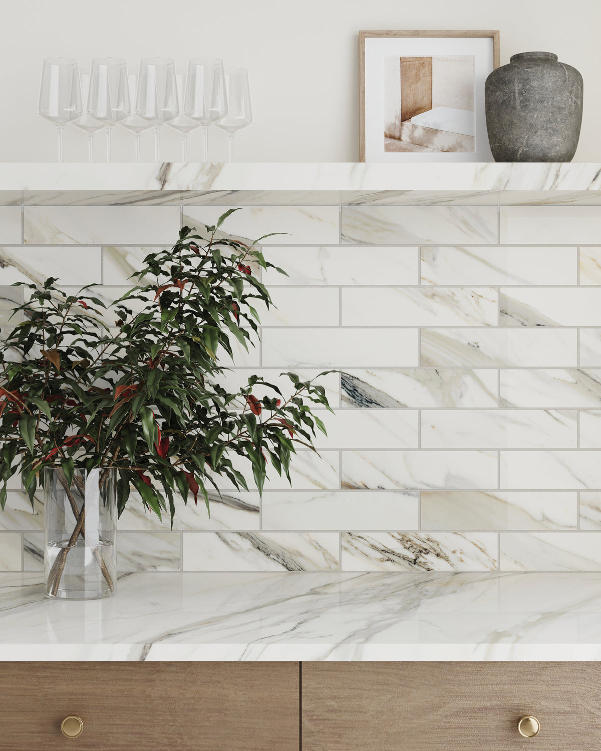 Elegant backsplash showcasing Calacatta Cremo polished marble look tiles in 3x12, featuring soft white tones with lght grey and beige veining for a refined look.