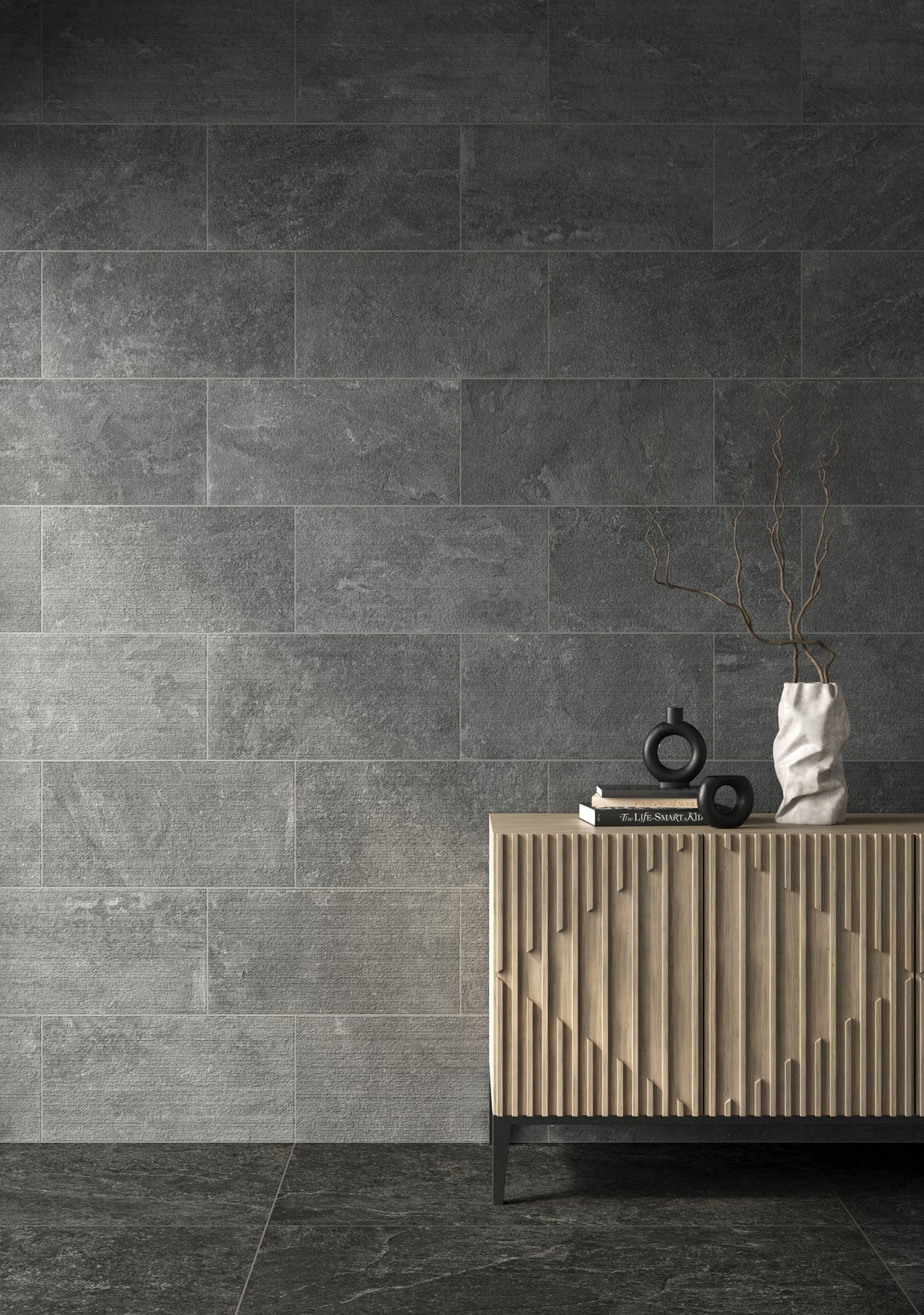 Sophisticated interior with 12x24 chiseled dark gray tiles, creating a textured, modern backdrop complemented by a stylish wooden console.