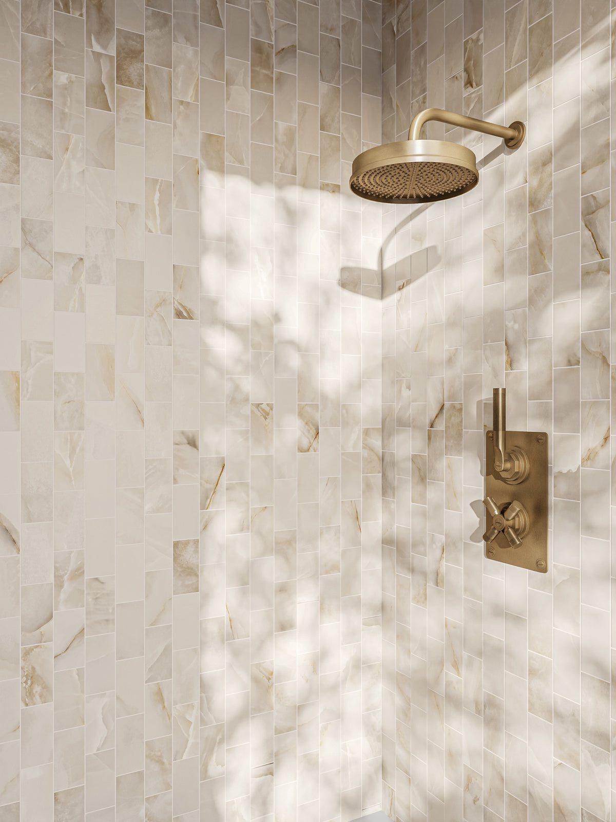 Shower walls adorned with Astrid matte porcelain tiles featuring elegant veining, paired with gold fixtures for a luxurious design.