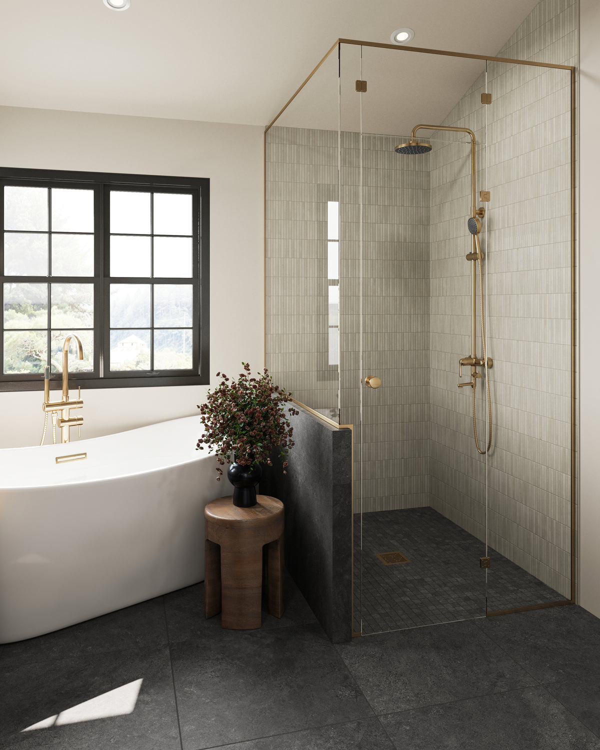 A modern bathroom showcasing black Adeline Midnight Matte tiles, a sleek white bathtub, a glass shower enclosure, and elegant gold fixtures.