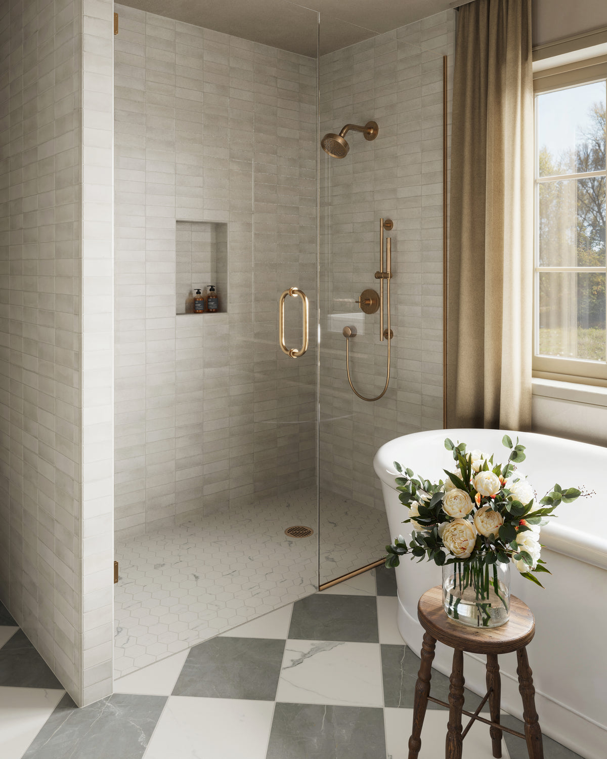 Elegant bathroom featuring Natasha 2x6 matte porcelain tile in Oat with a soft ivory white finish, paired with a gray and white checkered floor and brass fixtures.