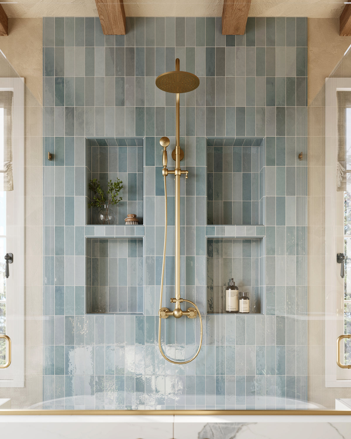 Stylish shower area with glossy blue vertical subway wall tiles and built-in niches, accented by elegant gold fixtures for a refined spa-like feel.