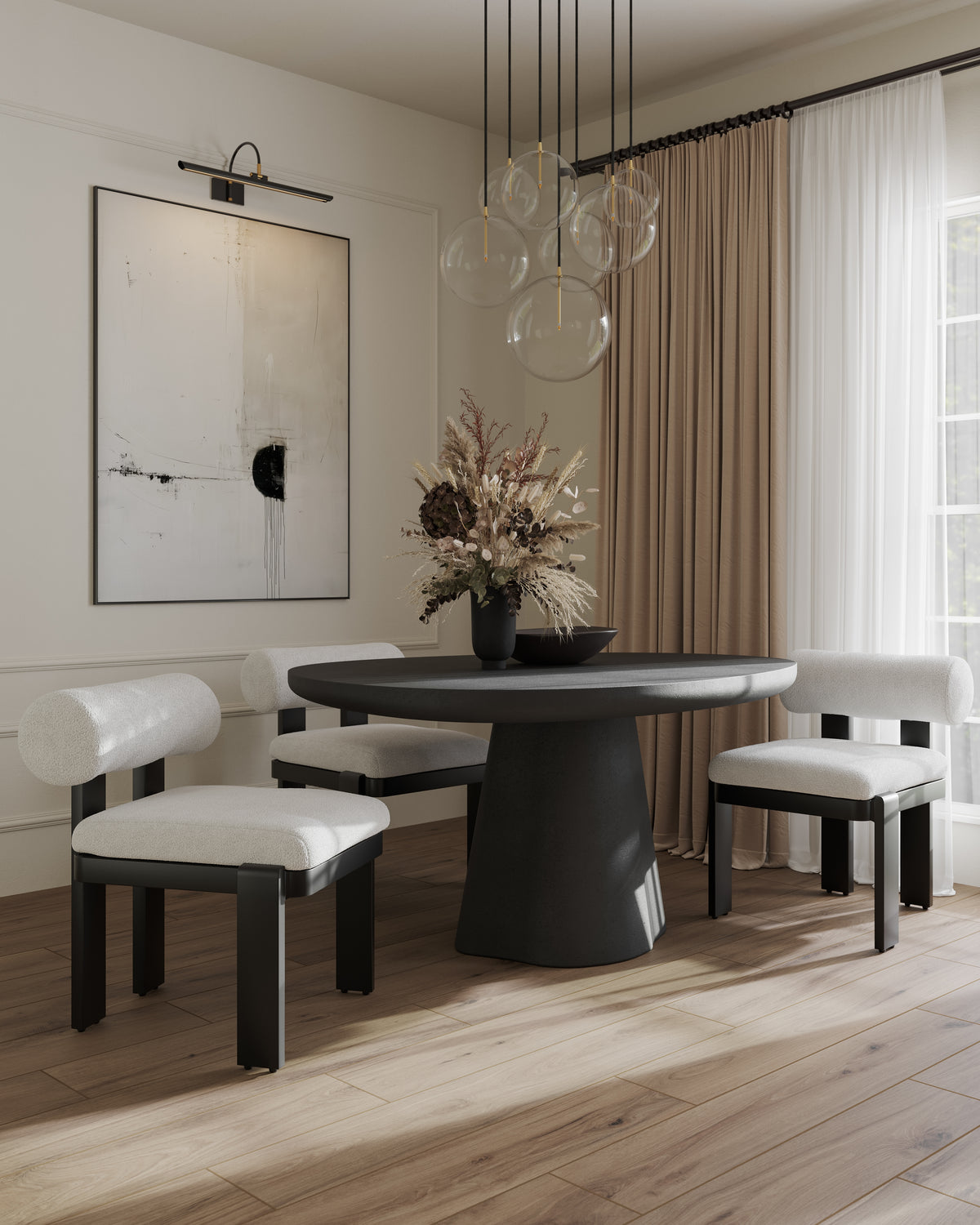Round black dining table with upholstered chairs, glass globe pendant light, abstract art, and soft neutral curtains in a bright room