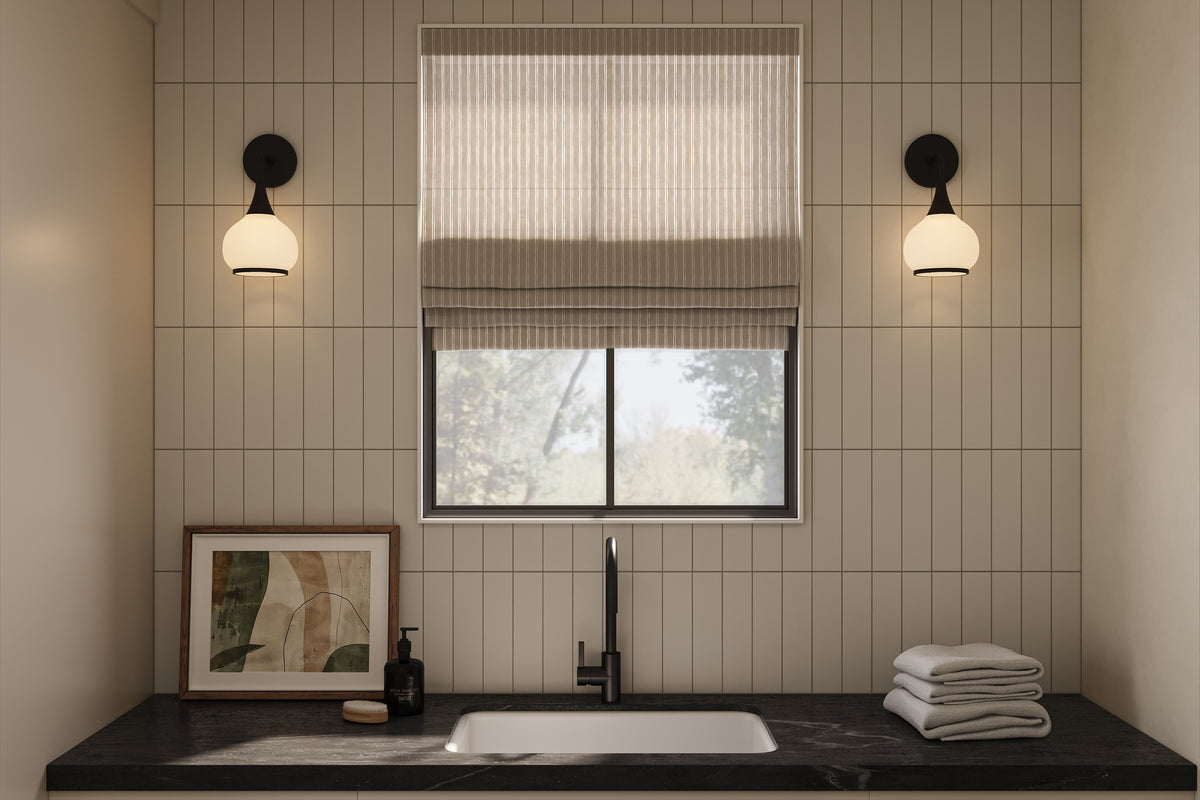 Elegant laundry or utility space with vertical off-white subway tile wall, black stone countertop, matte black faucet, and soft natural light through a wall sconce.