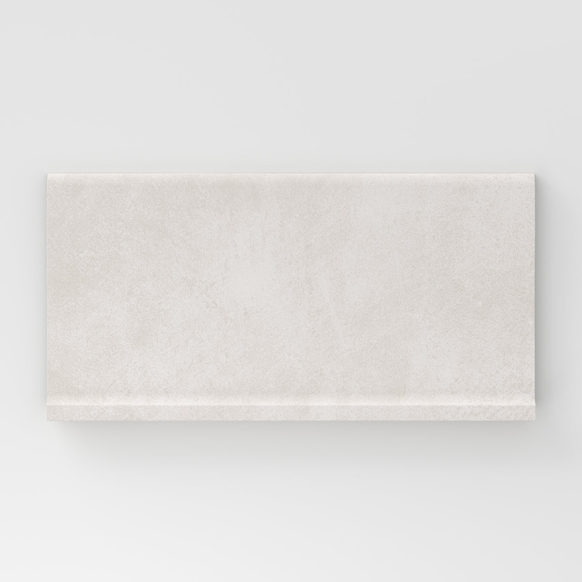 Rectangular porcelain cove base tile in a matte finish with a smooth, lightly textured surface, featuring a soft off-white to light ivory color with subtle natural variation.