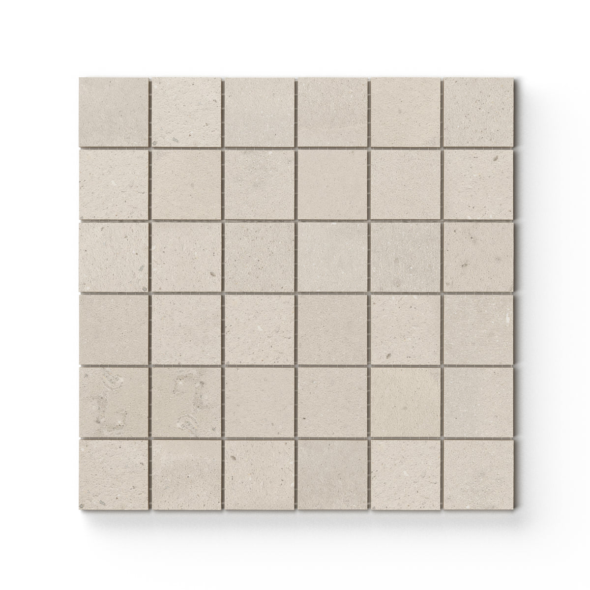 Taupe matte porcelain mosaic tile in a mesh-mounted square format, featuring visual mineral flecks inspired by the shifting texture of Italian Riviera sand.
