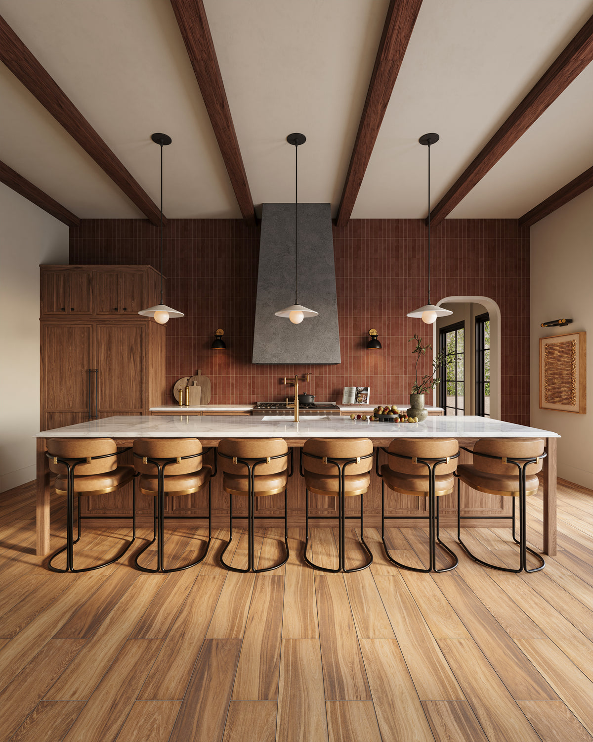 Modern rustic kitchen with matte wood look plank tile flooring in golden brown finish, terracotta subway tile backsplash, oak cabinetry, marble island with bar stools, sconces, wall art, and a trio pendant light.
