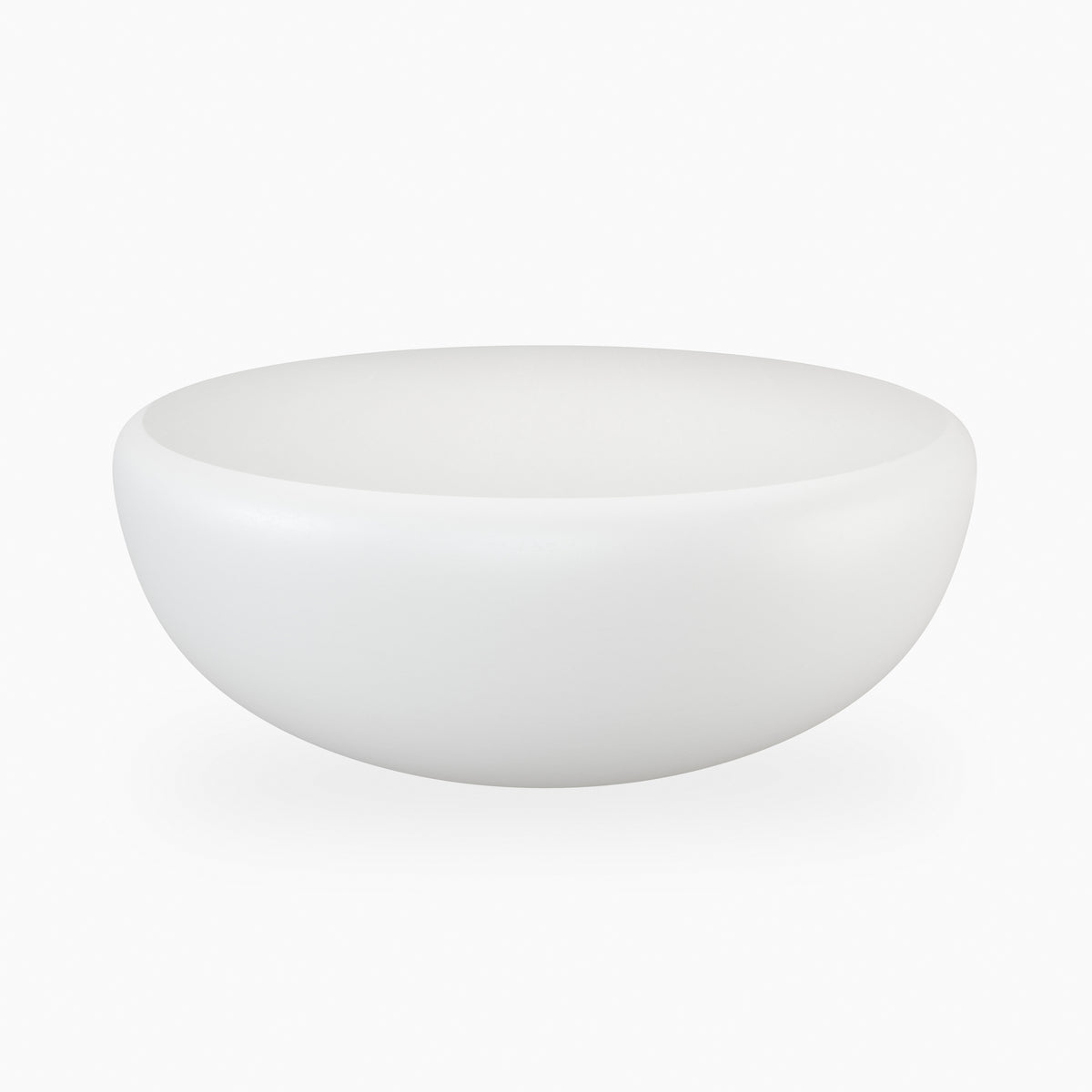 White outdoor coffee table with a broad round top, gently curved sides, and a seamless monolithic concrete form with subtle natural surface markings.