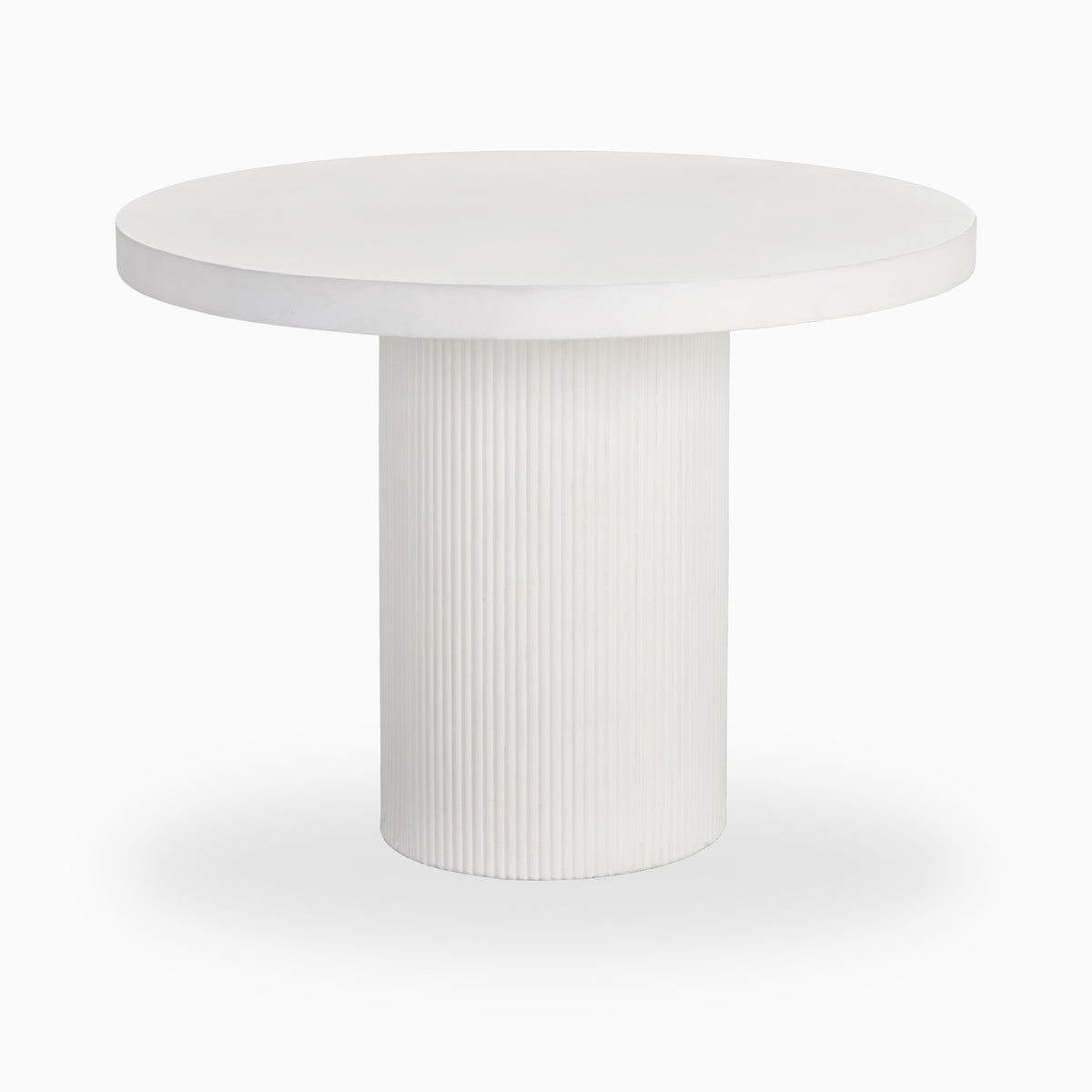 White round outdoor dining table with a smooth circular top, thick beveled edge, and fluted cylindrical pedestal base in a matte stone-like finish.