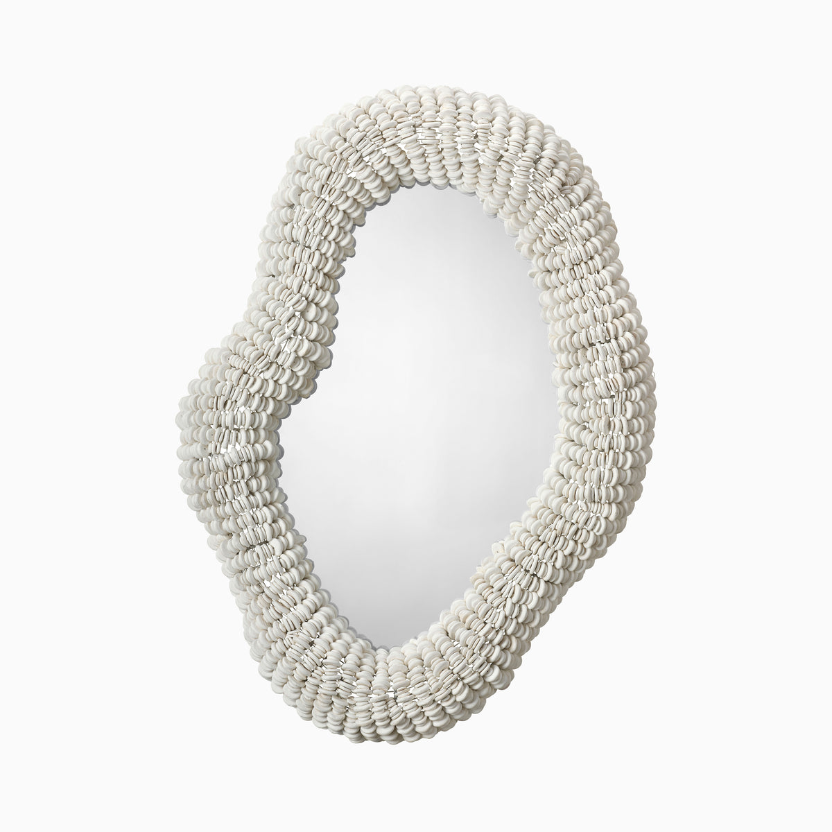 Organic oval wall mirror with a sculptural white shell-beaded frame, adding layered texture and coastal elegance to modern interiors.