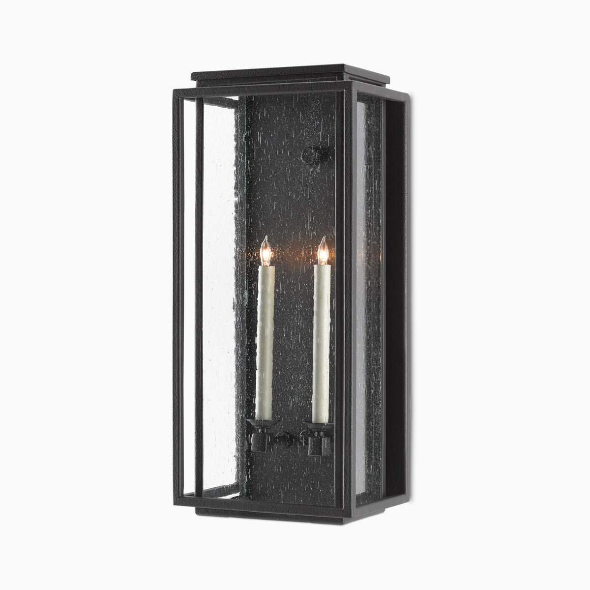 Black rectangular wall sconce with seeded glass panels and two lit candle-style lights on a plain white background.