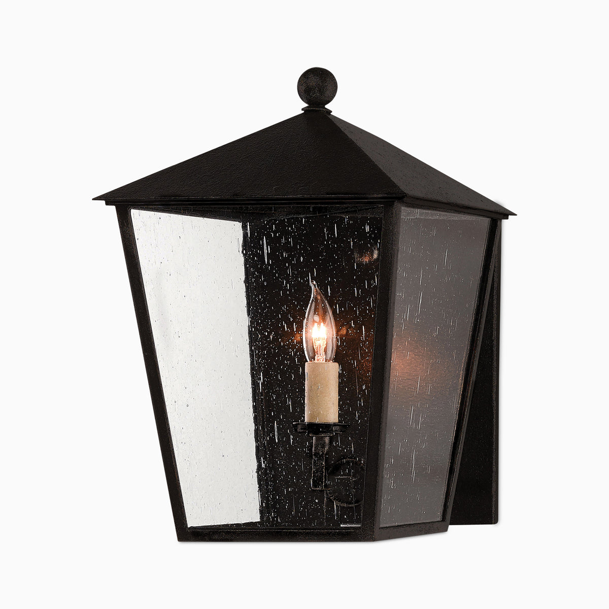 Classic black outdoor lantern-style wall sconce with seeded glass panels, candle-style bulb, and pitched top.