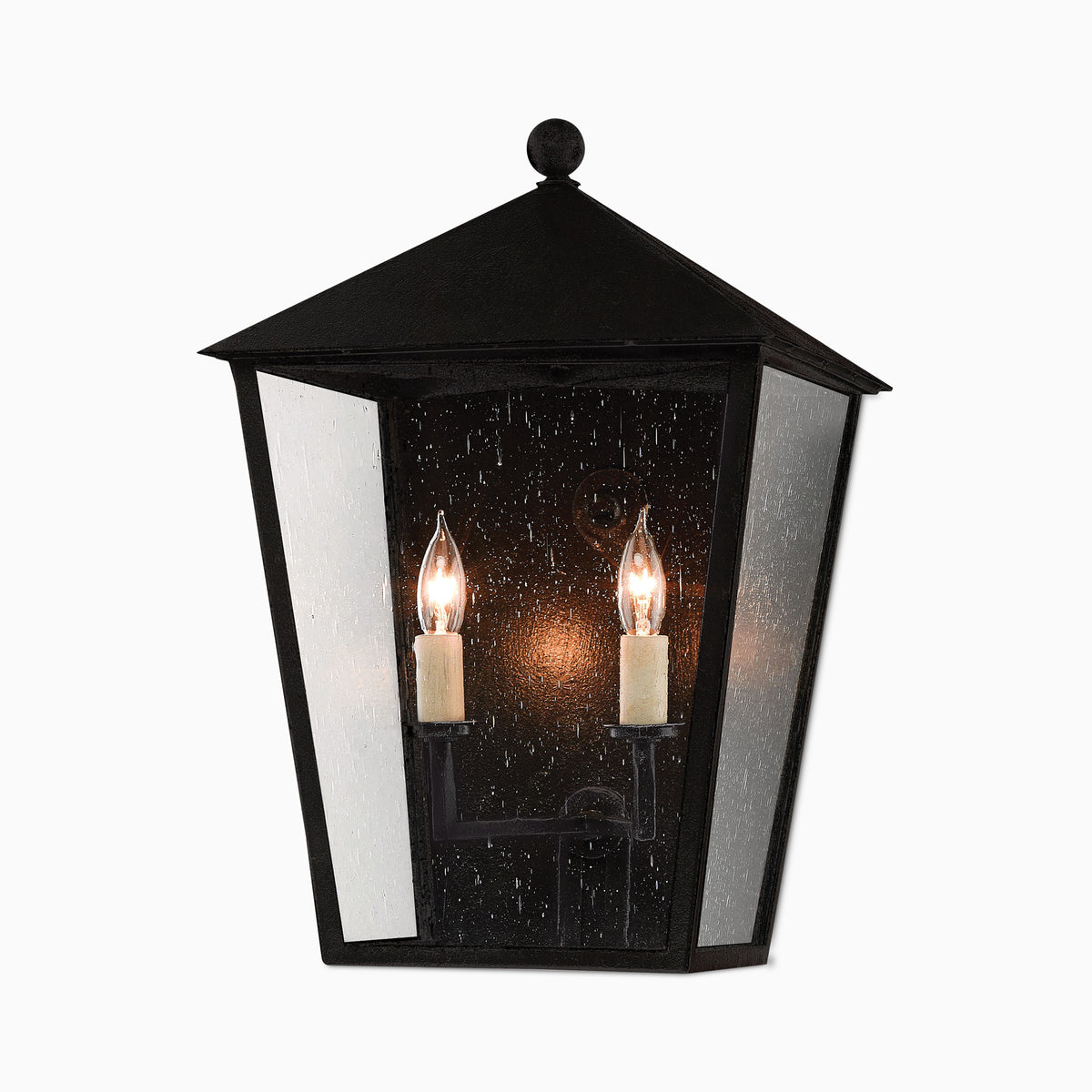 Classic black outdoor lantern-style wall sconce in medium size, with seeded glass panels, twin candle-style bulbs, and pitched top.