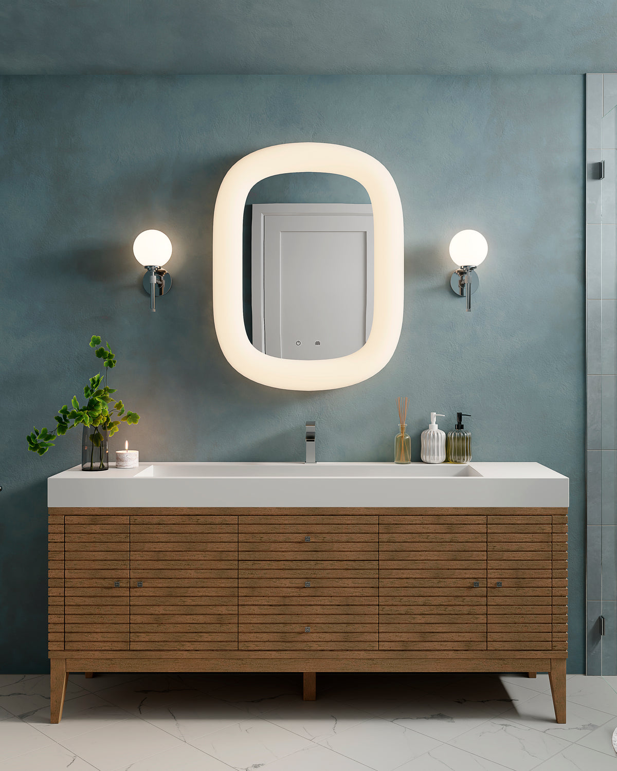 A blue textured wall and backlit mirror frame the Easton 72 inch single vanity in Whitewashed Walnut with slatted wood cabinetry and a glossy white composite stone countertop.