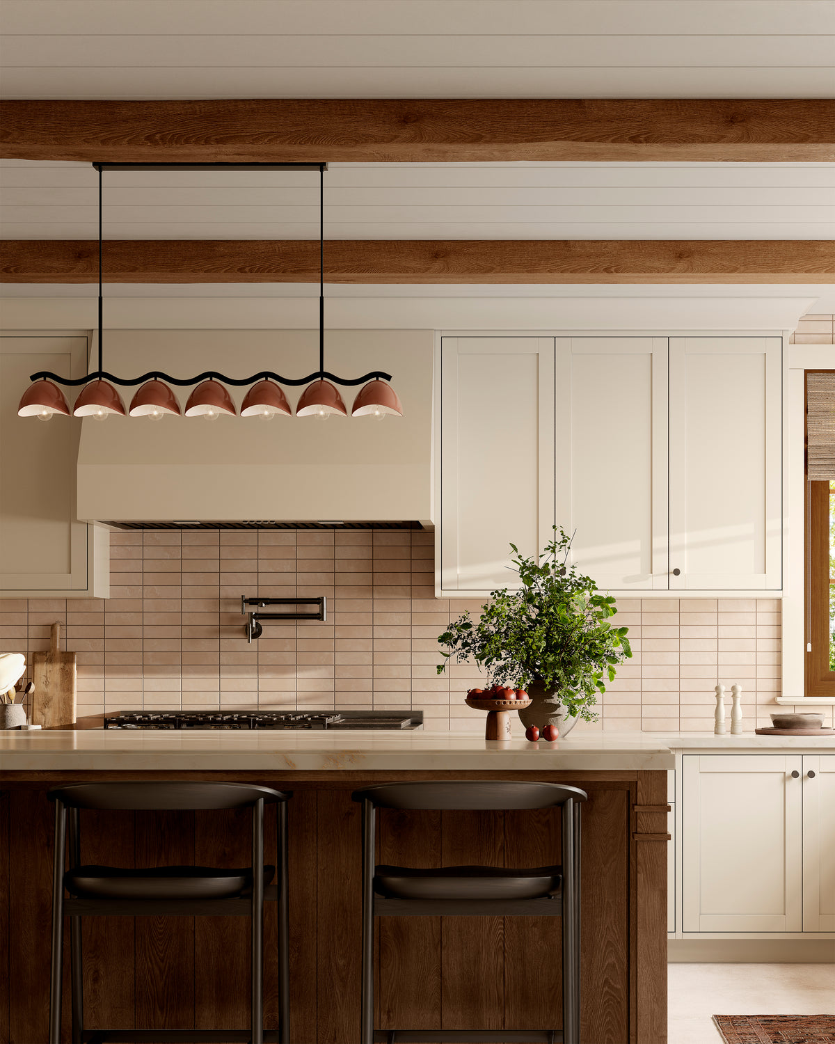 Modern kitchen with beige horizontal subway tile backsplash, wood island with black bars stools, and seven purplish, dark red dome linear pendant light under exposed beams.