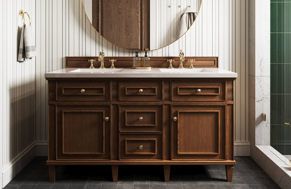 Classic bathroom vanity with rich wood cabinetry, brass hardware and faucets, set against striped wall paneling and a round mirror.