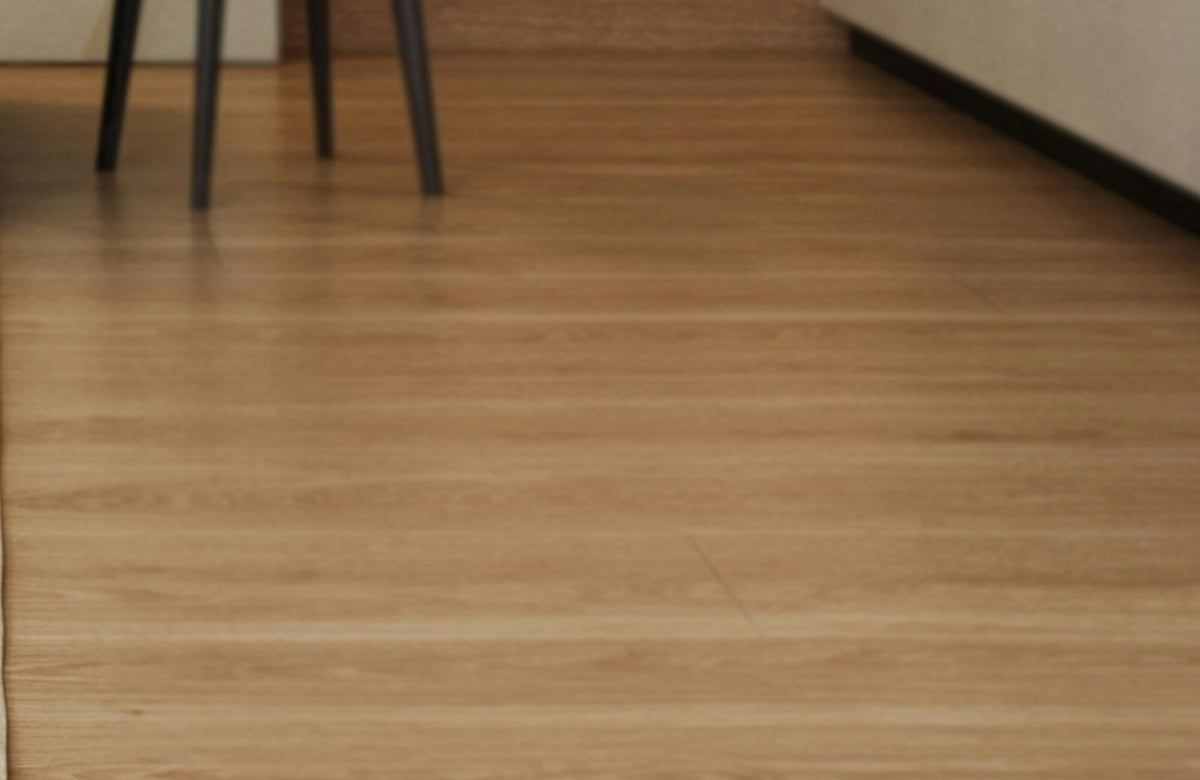 Warm-toned LVP flooring with natural wood grain texture enhances the space with a sleek, modern yet inviting appeal.