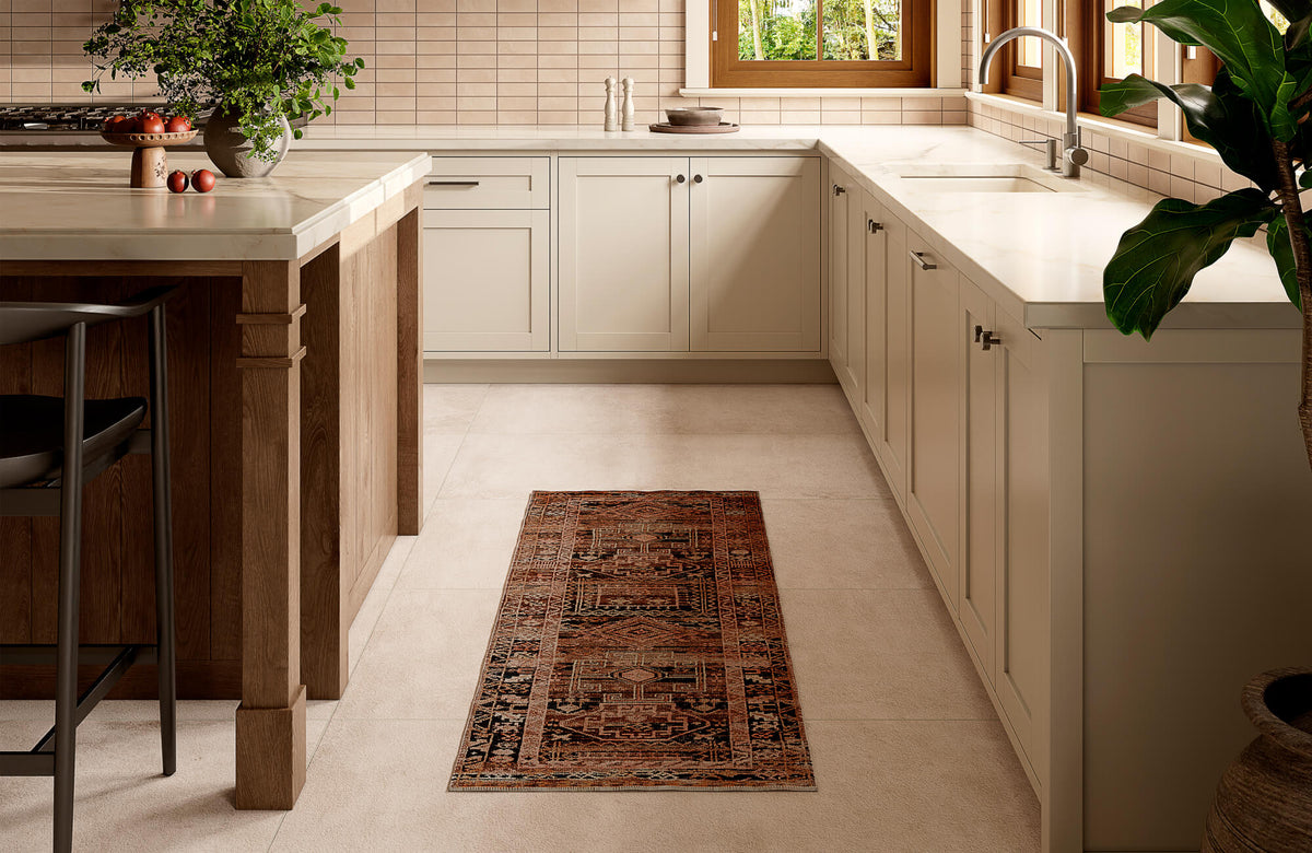 Narrow polyester runner rug placed along a kitchen walkway between cabinets and an island, showing proper sizing for clearance and proportion in compact spaces.